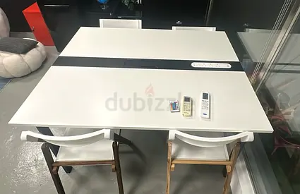 White extendable desk table with integrated power and one rectangular table