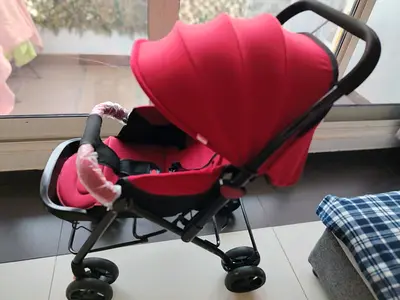 Lightweight red baby stroller/pram in good condition