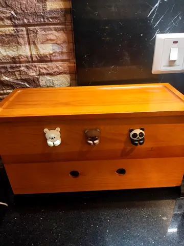 Small wooden bedside chest with cute animal knobs - charging station
