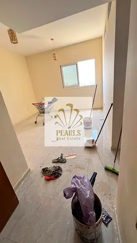 A one-bedroom apartment with a living room is available for annual rent in Al Jurf 3, Ajman. It features a practical layout and a bathroom, with an an