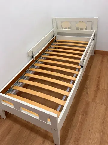 White wooden toddler bed with safety rails - good condition