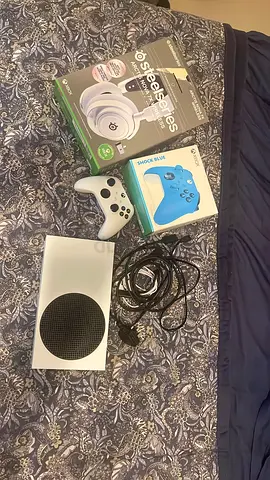 Xbox Series S console with controllers, SteelSeries wireless headset.