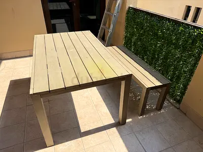Outdoor dining table with matching bench - weathered wood finish