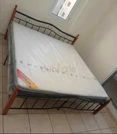 Metal bed frame with new mattress (King) — Brand New