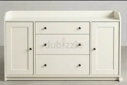 White wooden dresser with 3 central drawers and 2 side cabinets