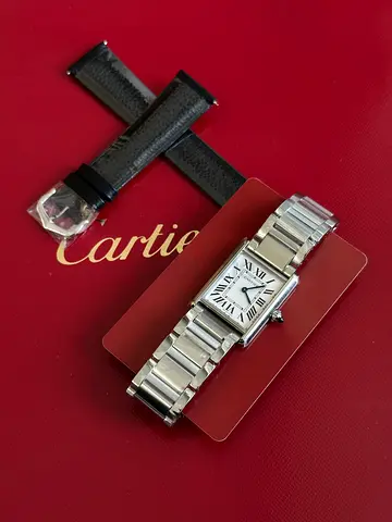 Cartier Tank Must watch, highlighted by its refined silvered dial with crisp black Roman numerals Su