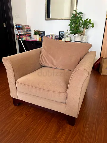 Single beige upholstered armchair with wooden legs - good condition, soft and very comfortable.