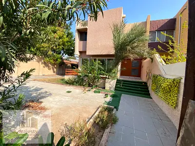For rent: a two-story villa in the Al Kharkan area, Sharjah Emirate. A spacious villa with two floors, a private garden, and a large yard.