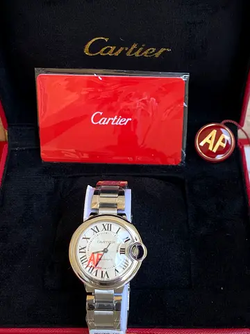 Cartier Ballon Bleu stainless steel automatic wristwatch presented in a red Cartier display box alon
