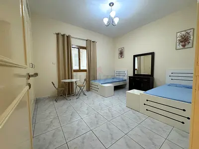Exicutive working 2 shearing girls bed space available in near karama center