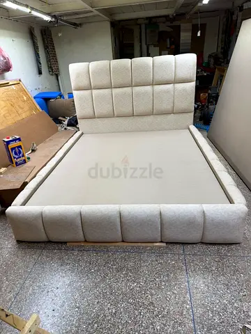 Beige upholstered Queen-size bed frame with padded headboard