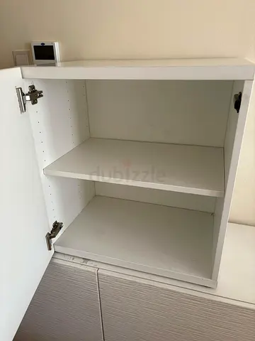 Compact Ikea Besta white storage cabinet with adjustable shelf and door.
