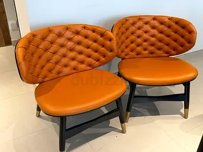 Pair of leather tufted lounge chairs — orange, modern design