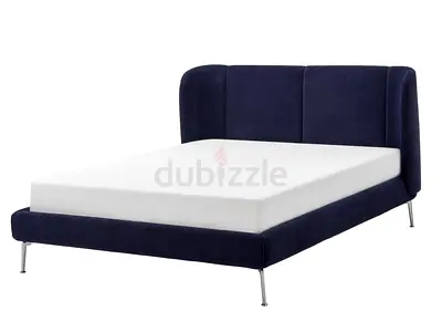 Modern blue IKEA double bed with metal legs