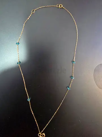 Delicate gold chain necklace (18 carats) with blue gemstone accents