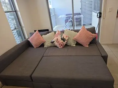 Grey L-shaped Sofa Bed with Cushions - Good Condition