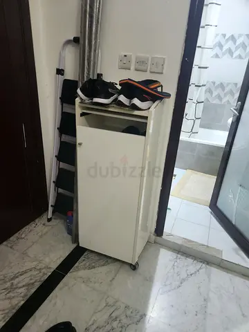 Small white storage cabinet with shelves and wheels - good condition