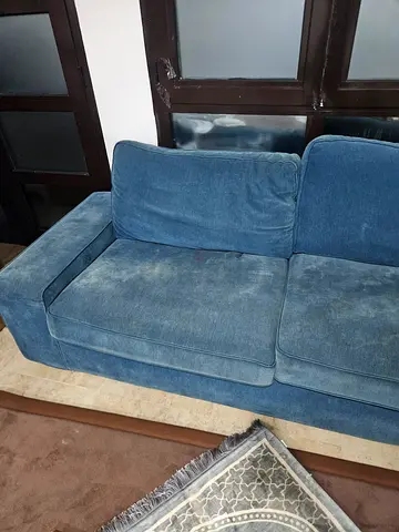Blue 2-seater fabric sofa in good used condition