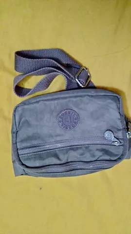 Small grey crossbody shoulder bag with adjustable strap