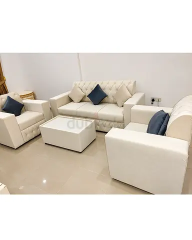Beige color 5 seater sofa we are selling with mixed pillows and table you can get from us
