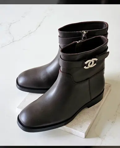 Chanel Black leather ankle boots with silver logo buckle