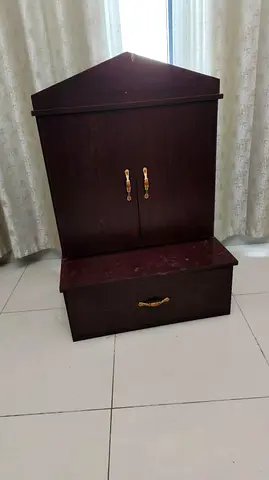 Dark wood Pooja cabinet with top doors and bottom drawer for sale .