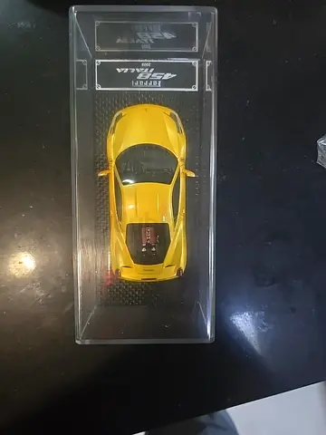 Diecast Ferrari F12 Model Car (Yellow) in Display Case.