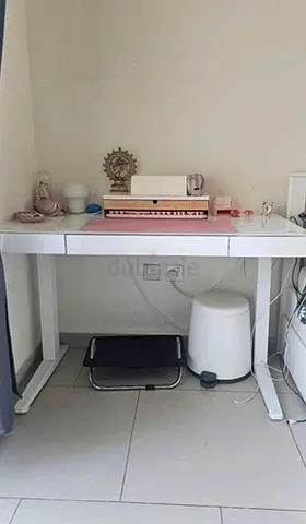 IKEA-style white adjustable smart desk with built-in Bluetooth speaker