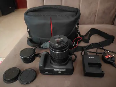 Canon EOS DSLR 1300D body with lens, battery grip, charger and camera bag