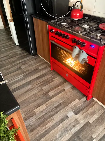 Red freestanding gas range with oven - good working condition