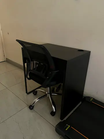 Black mesh office chair with small black side cabinet