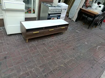 Low wooden TV cabinet with marble top and brass handles