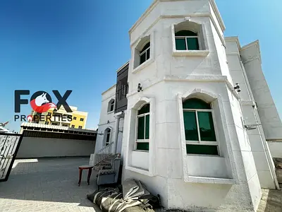 Commercial villa for rent in Al Rawda 1, Ajman. 8 rooms, 4 bathrooms, hall, majlis, covered areas, large yard and spacious outdoor setback. Suitable f