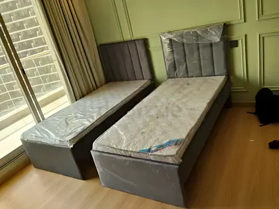 Pair of single beds with mattresses - grey upholstered frames