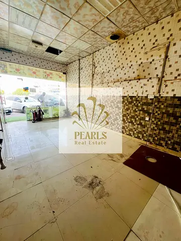 Commercial shop for rent in Al Rawda 2, Ajman, located on a main road near Sheikh Ammar Street; suitable for various business activities, at an annual