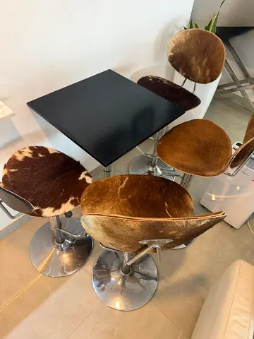 Set of 4 Cowhide Bar Stools with Chrome Base and Black Table Top