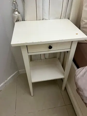 White wooden bedside table with single drawer with bed