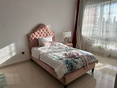 Single pink upholstered bed with tufted headboard - good condition