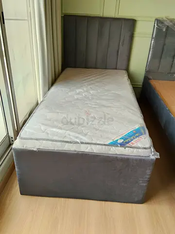Single grey upholstered bed with mattress - good condition