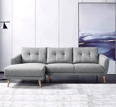 Light grey L-shaped fabric sofa with chaise, modern design