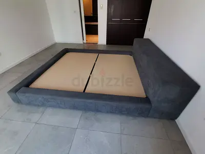 Large grey upholstered platform bed frame with headboard - queen/king size