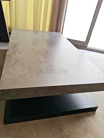 Modern rectangular concrete-look coffee table with black base