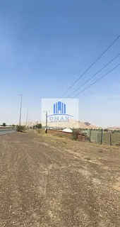 For sale, 4 commercial, residential, and agricultural lands in Al Madam, on a main street