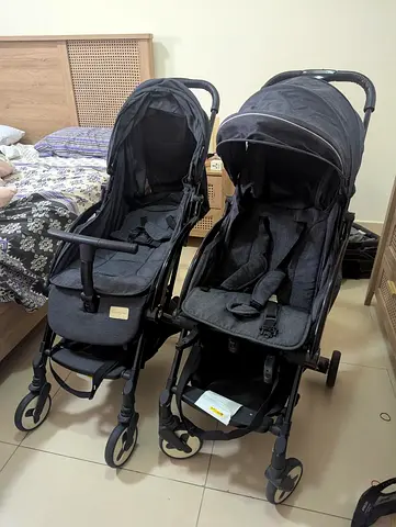 Pair of well-used lightweight single strollers - matching dark grey