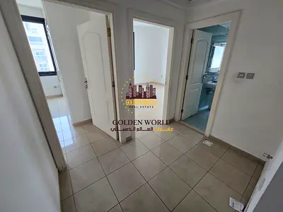 For annual rent in Al Majaz 3, a fully renovated 2-bedroom apartment with a living room, free AC, renovated kitchen open to the hallway, built-in ward