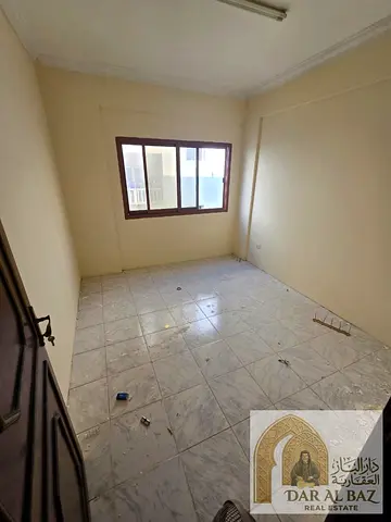 Two-bedroom apartment with a living room available for annual rent in the Al Butina area of Sharjah. Features central air conditioning, a bathroom,
