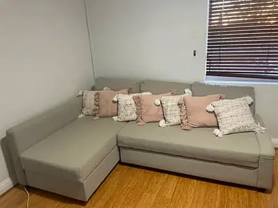 Light grey L-shaped sofa bed with chaise - good condition