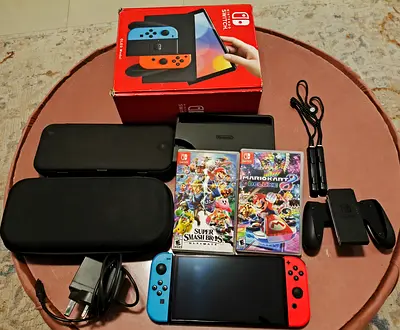 Nintendo Switch console with Joy‑Cons, dock, 2 games (Smash Bros & Mario Kart) and accessories