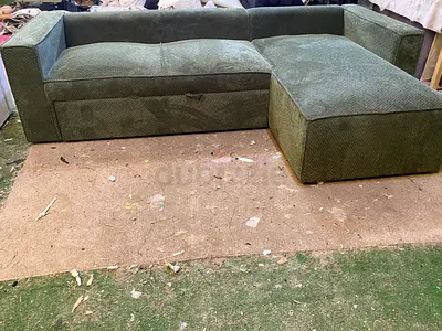 Green L-shaped fabric sofa with storage - used