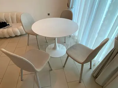 White round dining table with 4 beige upholstered chairs - very good condition